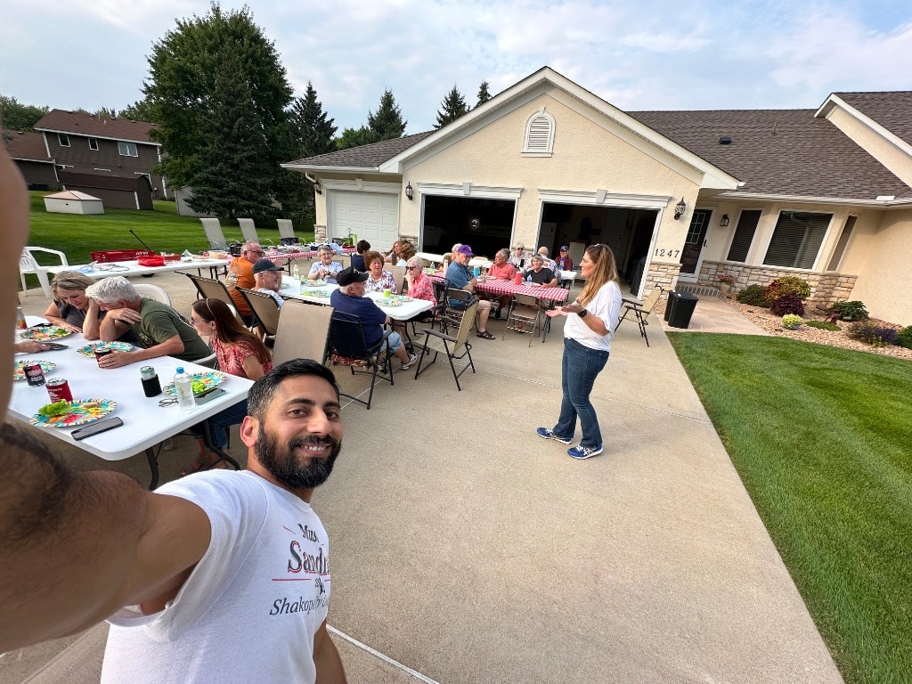 Large family gathering on a residential driveway