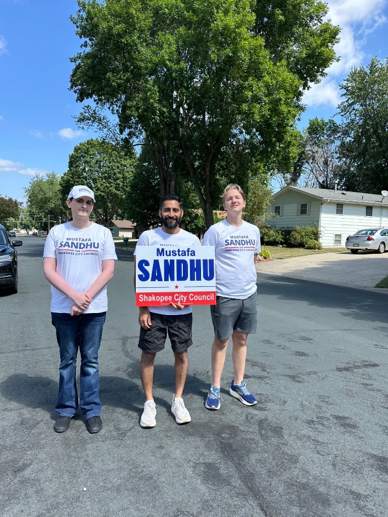 Three people campaigning for Sandhu City Council