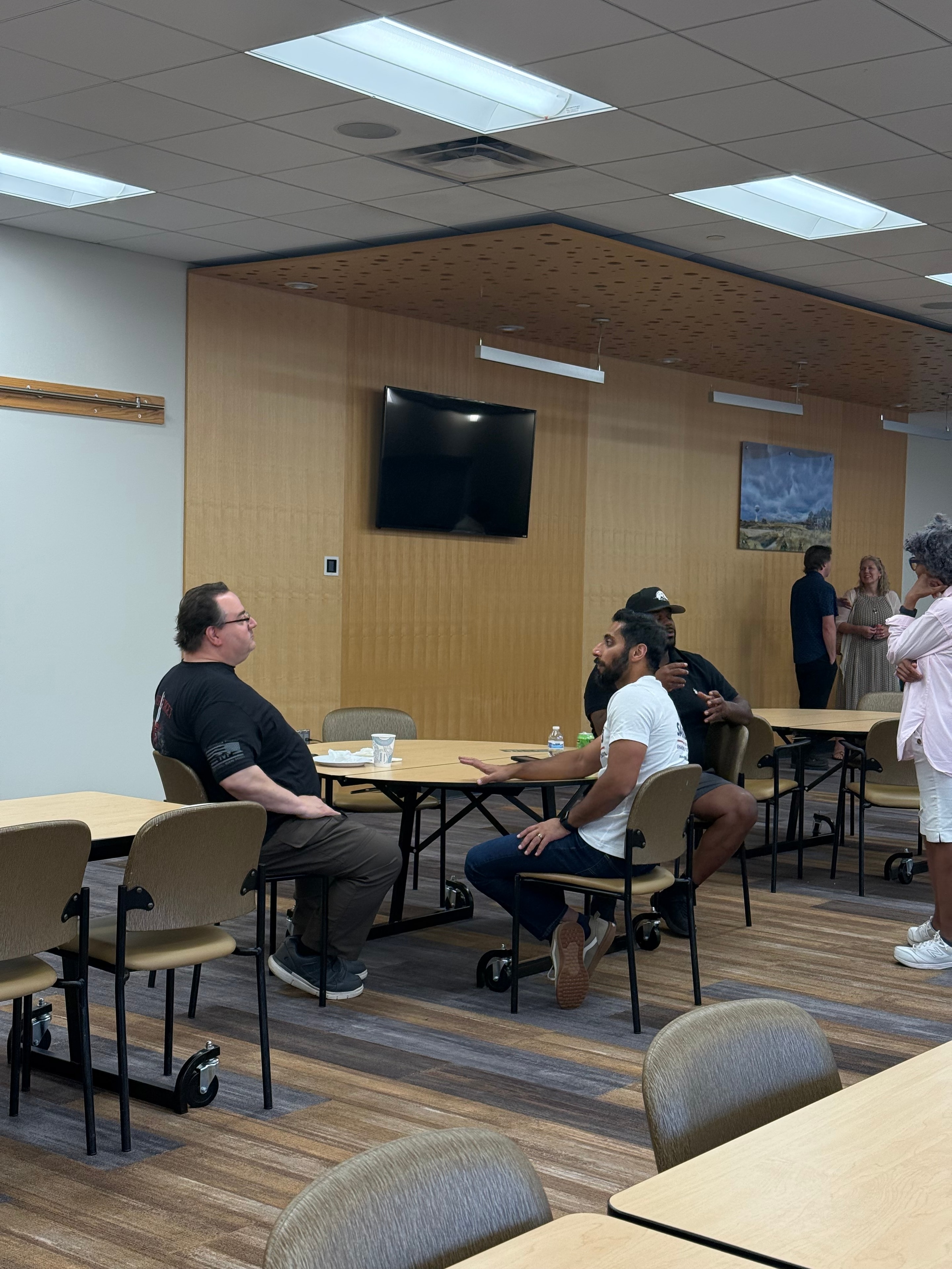 People conversing in a modern office meeting room