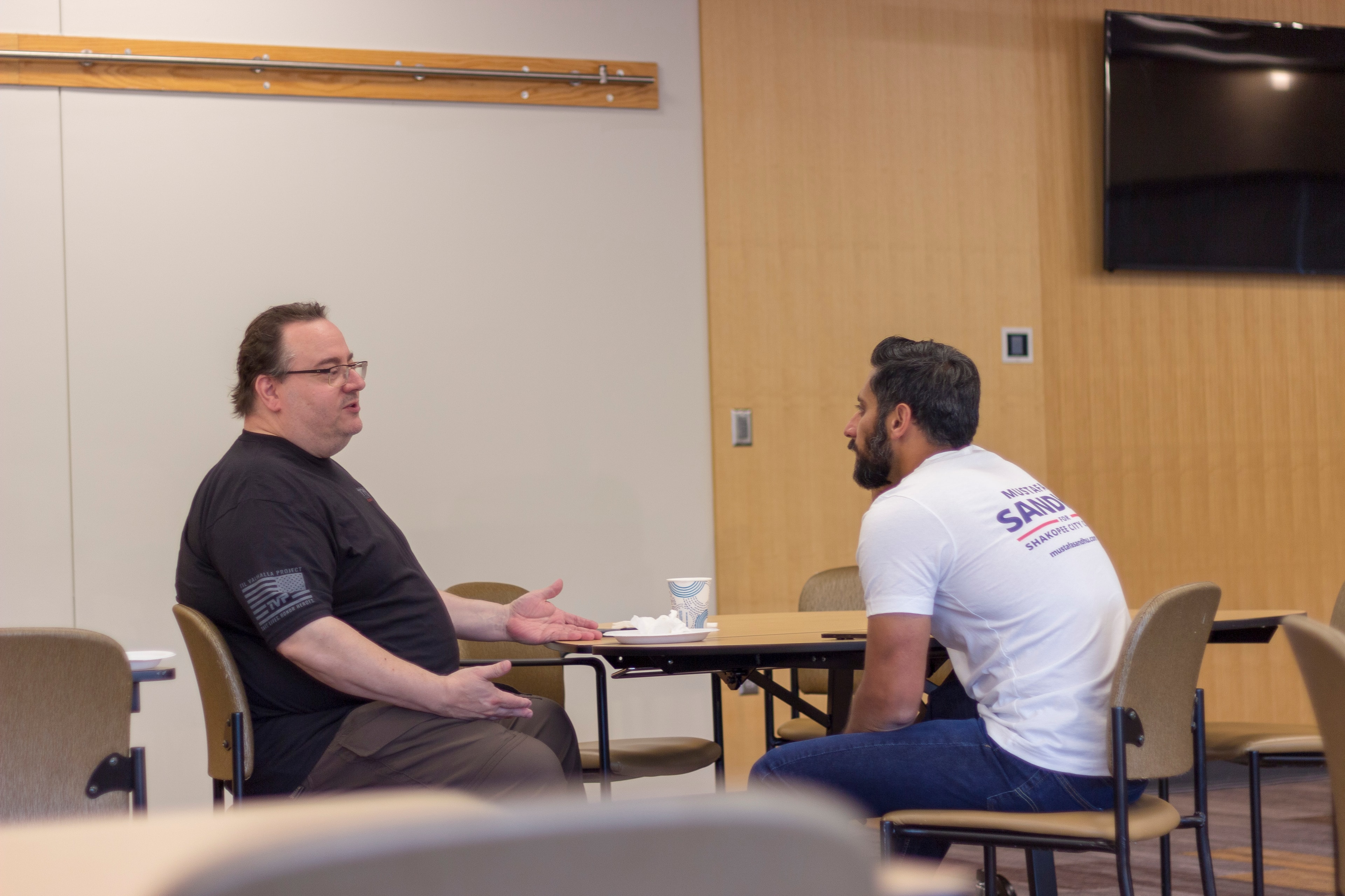 Two men having a conversation in a meeting room