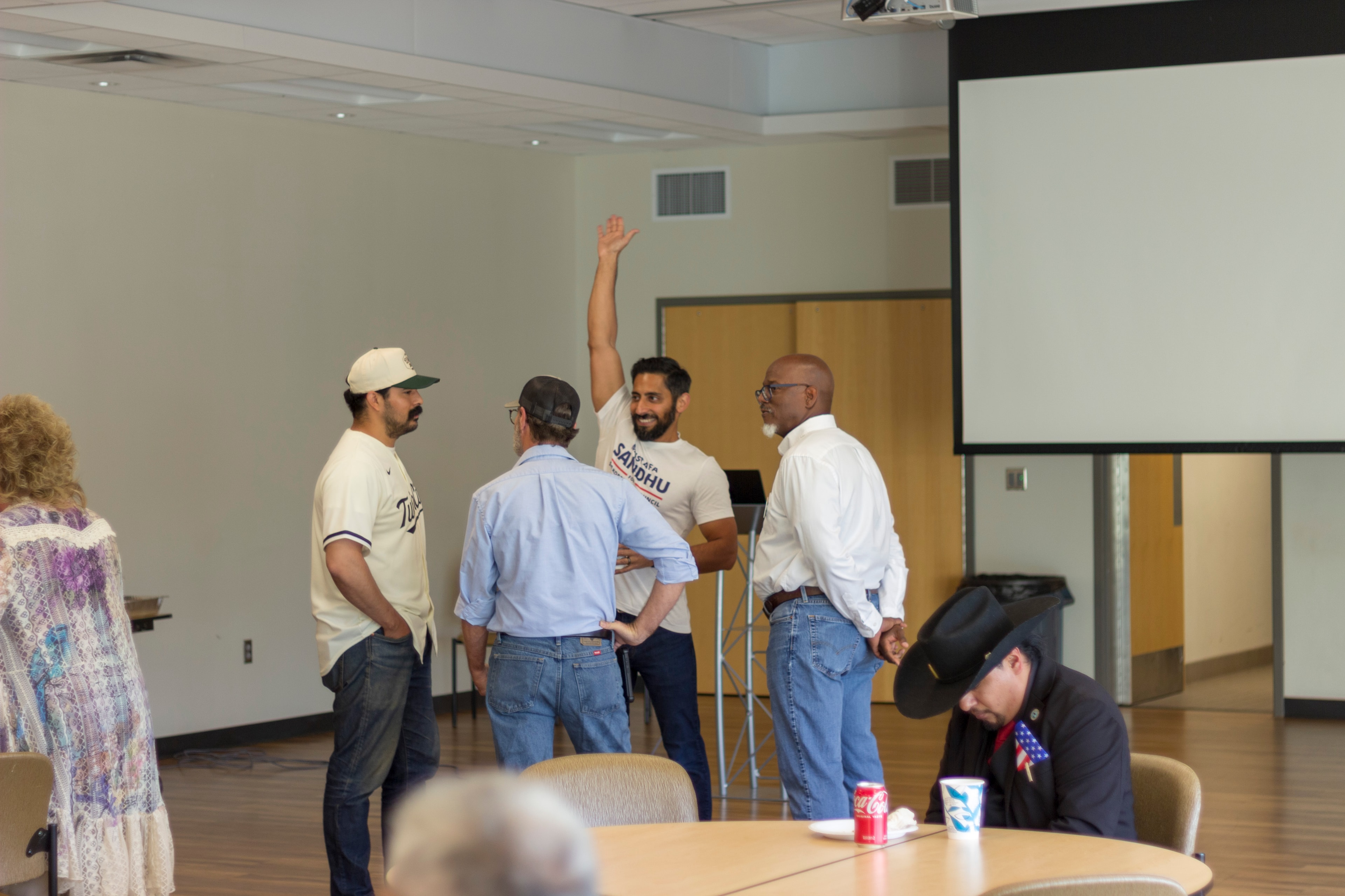 Mustafa Sandhu waving and engaging with attendees at the meet and greet