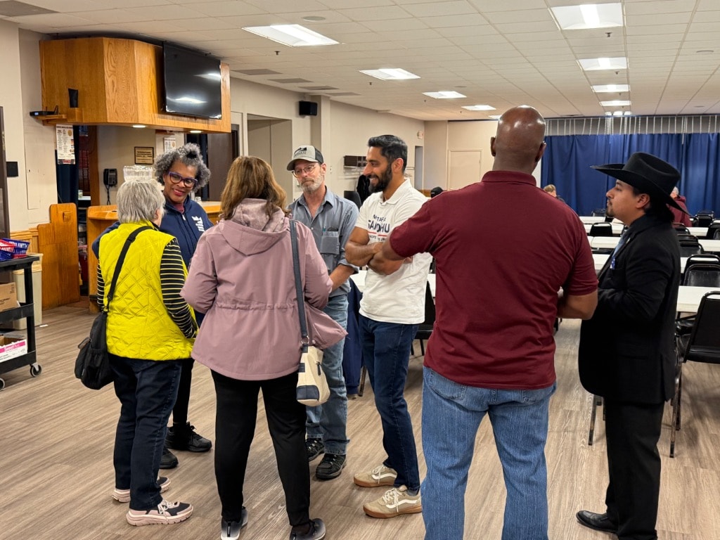 Mustafa Sandhu meeting with community members at indoor event